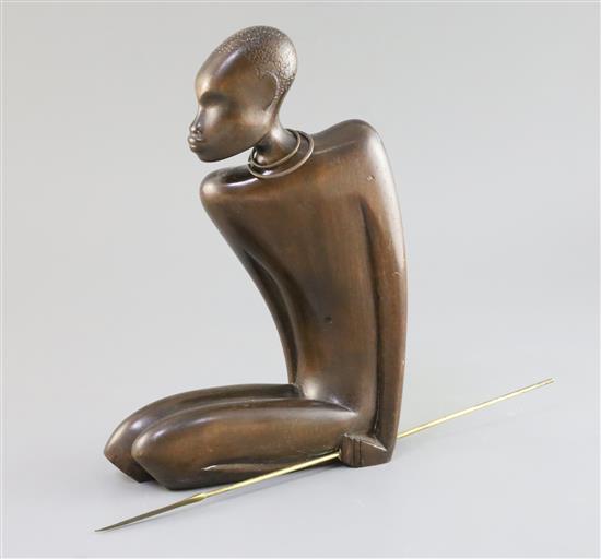 A Hagenauer hardwood figure of a kneeling native man holding a brass spear, height 10.5in.